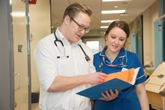 2 Staff looking at file