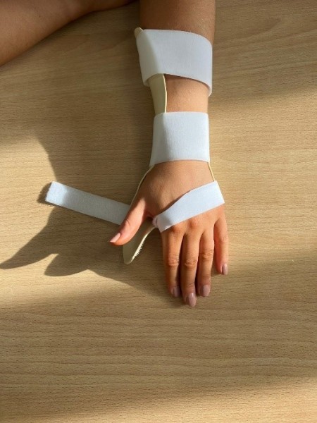 C. Lift your thumb straight off the splint